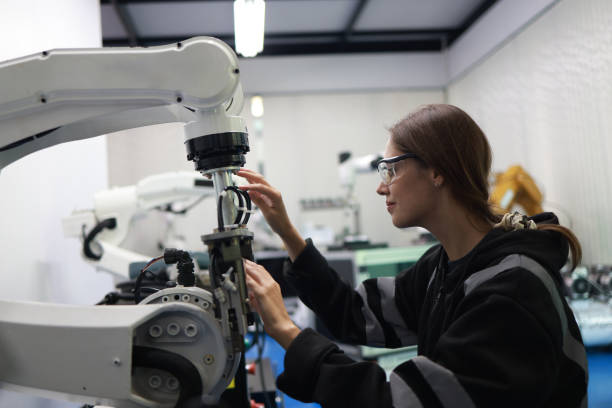 istock Factory Female Industrial Engineer working with automation robot arms machine in intelligent factory industrial on real-time monitoring system software.Digital future manufacture. 2003145676