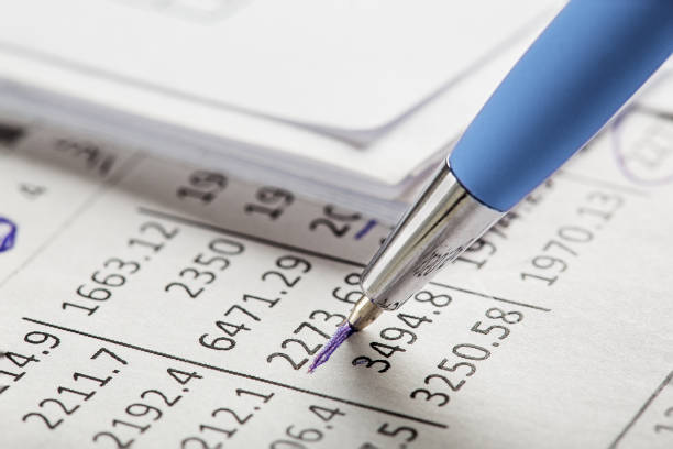 Checking the value of securities. Pencil, share listing and checking financial chart. Concept of banking, financial report and financial audit.