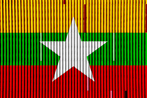 Flag of Republic of the Union of Myanmar on a textured background. Concept collage.