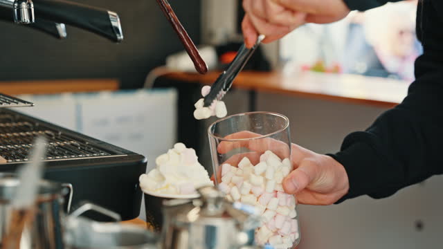 SLO MO Closeup of Male Food Truck Owner Garnishing Marshmallows over Whipped Cream while Preparing Coffee