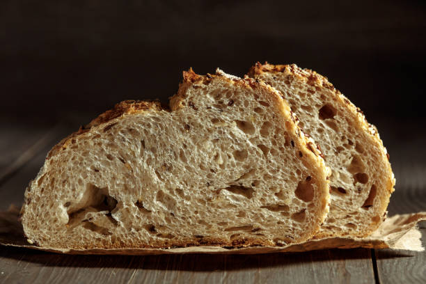 istock Bread, traditional sourdough bread cut into slices on a rustic wooden background. Concept of traditional leavened bread baking methods. Healthy food. 2003215682