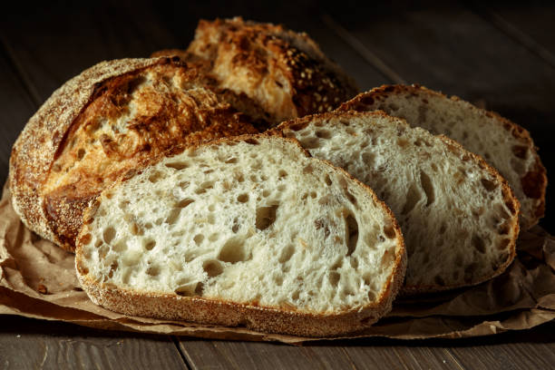 istock Bread, traditional sourdough bread cut into slices on a rustic wooden background. Concept of traditional leavened bread baking methods. Healthy food. 2003215688