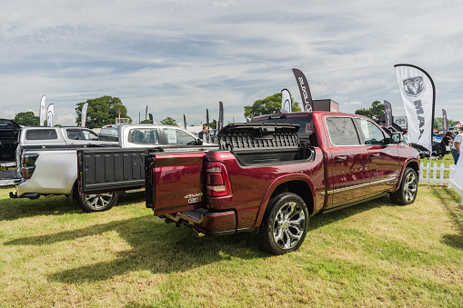 Nantwich, Cheshire, England, July 26th 2023. Red Ram 1500 pickup truck at a trade show stand, automotive lifestyle editorial illustration.