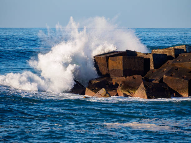 Waves breaking on concrete blocks in Pueto de la Cruz, Tenerife