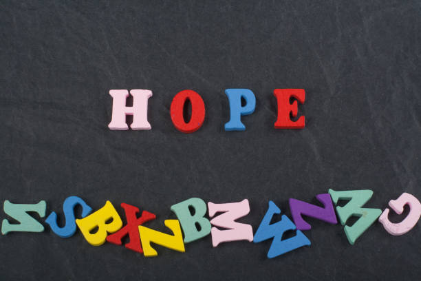 istock HOPE word on black board background composed from colorful abc alphabet block wooden letters, copy space for ad text. Learning english concept. 2003261655