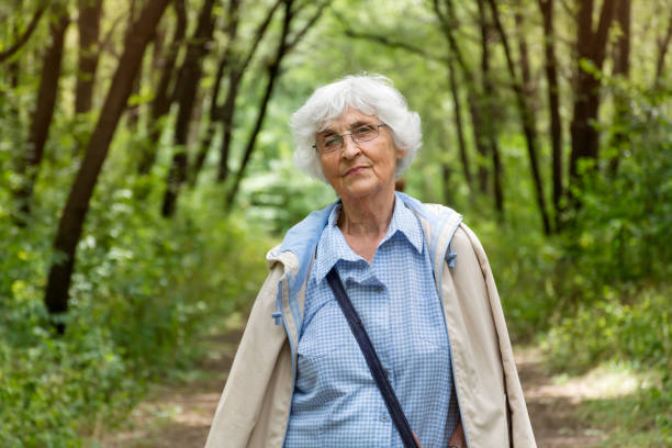 istock Senior  woman relaxing  in outdoors park 2003296871