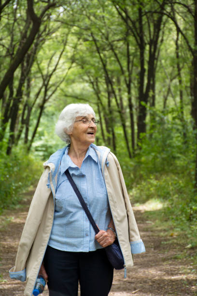 istock Senior  woman relaxing  in outdoors park 2003305297