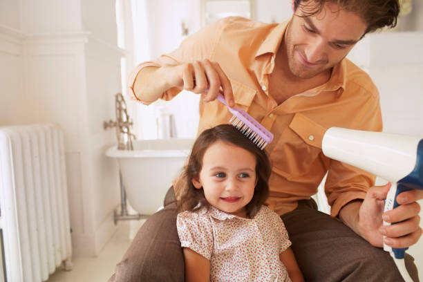 Father blowdrying daughter's (2-4) hair in bathroom, close-up (Digital Composite) dv stock pictures, royalty-free photos & images