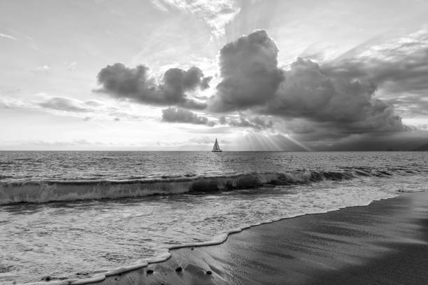 istock Sailboat Sun Rays Sunset Ocean Clouds Inspirational Divine Sunburst Sunbeams Black And White Image 2003324980
