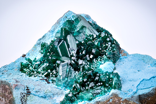 raw emerald gemstone (mineral beryl)  with inclusions mined in Brazil isolated on white