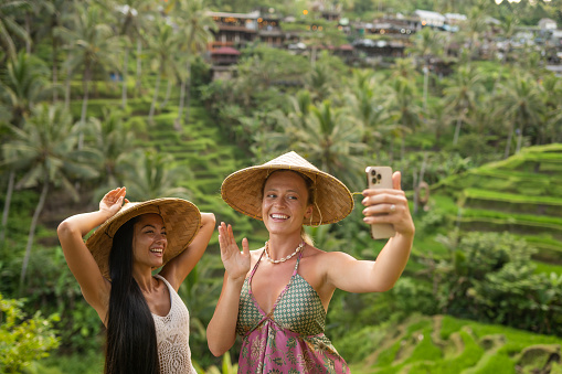 Female friends taking selfie at the beautiful tegalalang rice terrace in Bali, Indonesia