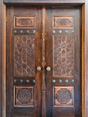 mosque door background photo. The names of Allah and Muhammad are written on the wooden door. Taken in daylight with a full frame camera.