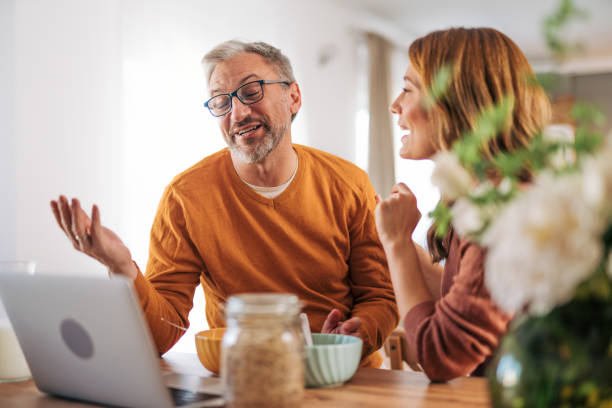 istock Mature couple using laptop and having breakfast. 2003374435