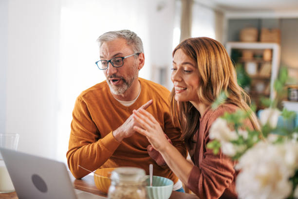 istock Mature couple using laptop and having breakfast. 2003374967