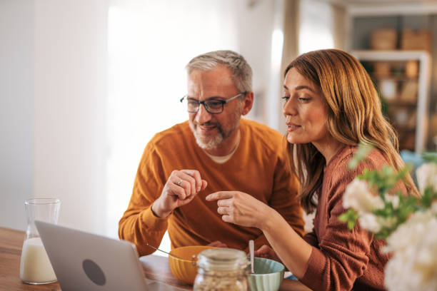 istock Mature couple using laptop and having breakfast. 2003375493