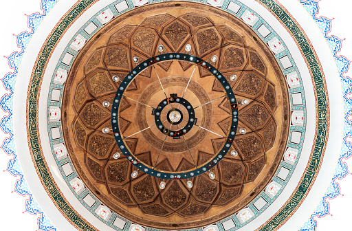 Bottom angle view of the mosque dome. The names of Allah and Muhammad are written on the wooden door. Taken in daylight with a full frame camera.