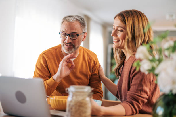 istock Mature couple using laptop and having breakfast. 2003377099