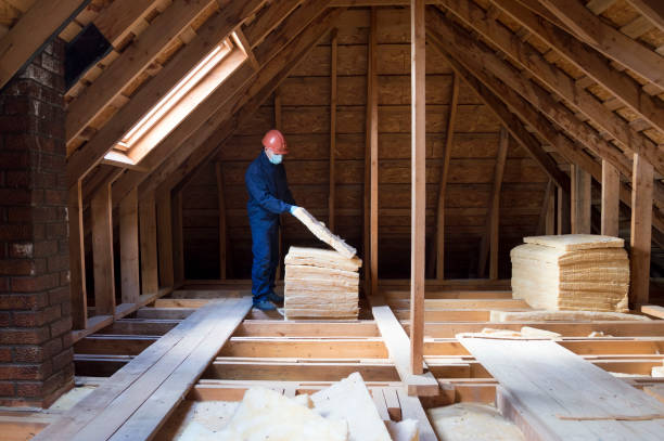 istock Roof insulation. A worker puts glass wool insulation in the attic. 2003399178