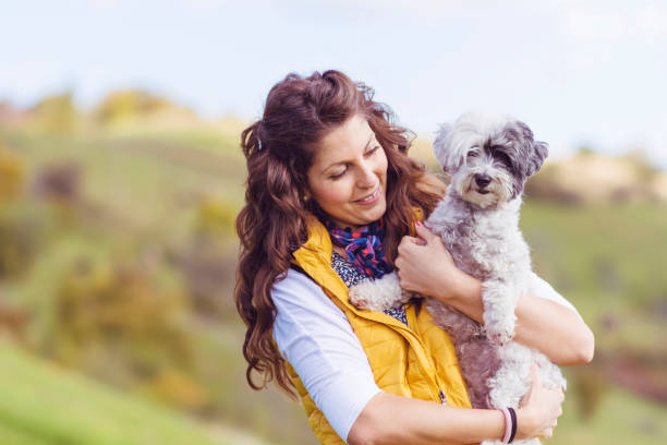 istock Woman hugging her havanese dog outdoor 2003408718