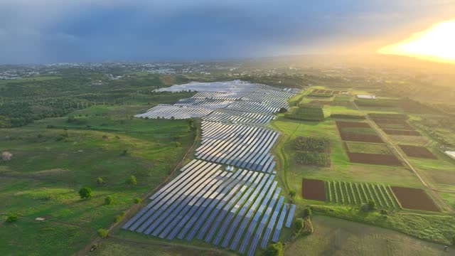 Beautiful Aerial Drone View Of Large Solar Panel Installation In Lush Green Landscape