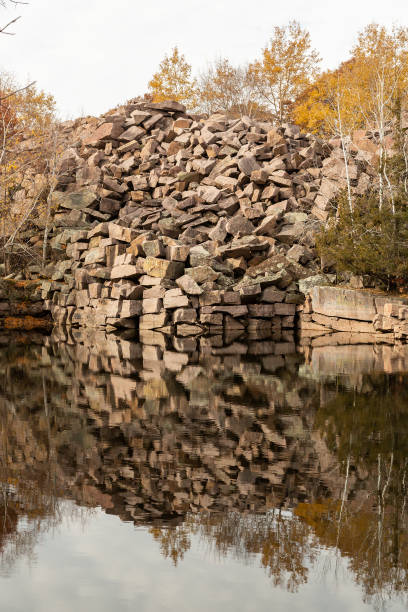 Piles of unused granite pieces (called grout) at an old granite quarry in autumn.