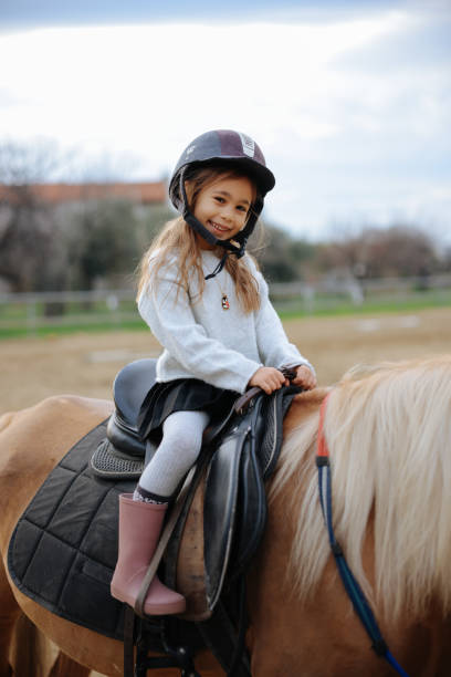 istock Beautiful girl getting ready to ride her horse 2003459122