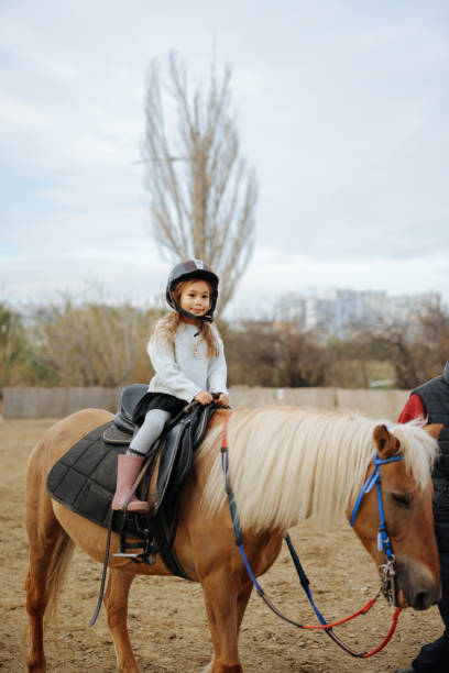 istock Beautiful girl getting ready to ride her horse 2003459660