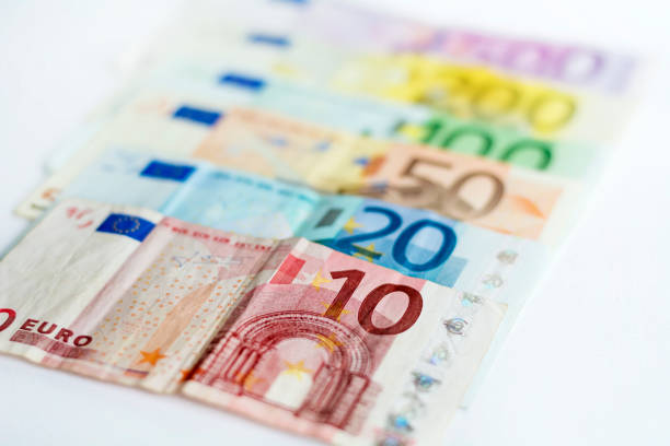 Euro (EU) banknotes in a row, official currency of Europe with white background for copy space