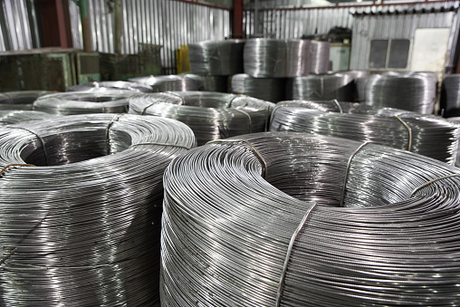 Rolled metal wire in reels is stored in a warehouse in packages