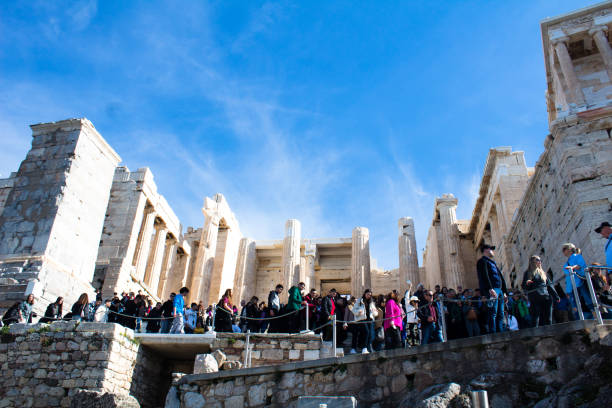 Athens, Attica, Greece - February 04, 2024: Visitors and tourists at the Acropolis in Athens, Greece are queuing in front the Propylaea on their way to visit the Parthenon