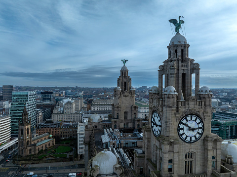 An aerial photograph of Liverpool Parish Church and the mythical Liver Birds sitting atop one of Liverpools iconic buildings on Liverpool Waterfront in Merseyside, England. The photograph was created high above the rooftops and also shows the wider city centre.