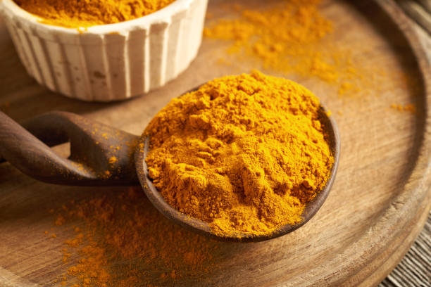 istock Dry turmeric root powder on a spoon on a table 2003518915