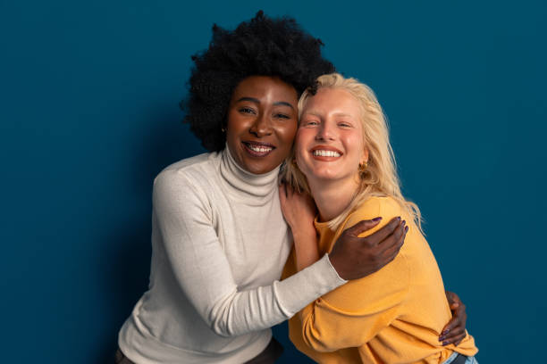 istock Cheerful young women with different skin tones smiling at camera 2003526858