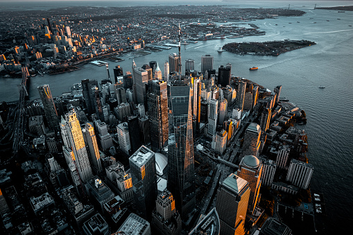 Amazing view of Lower Manhattan with all the famous buildings and skyscrapers captured from a helicopter during moments after sunset.