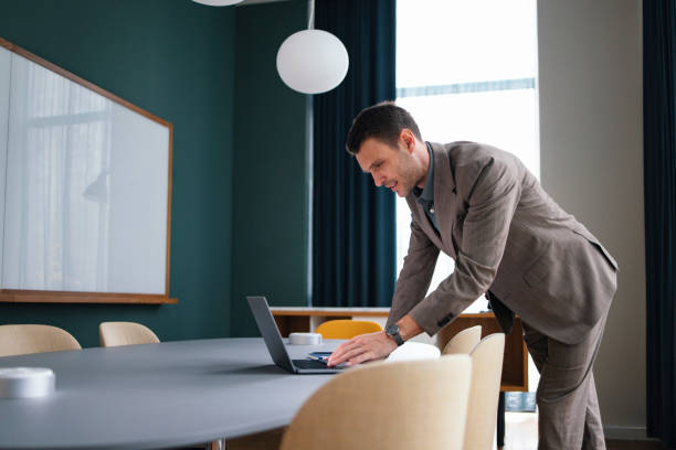 Professional Businessman Working on Laptop in Modern Office