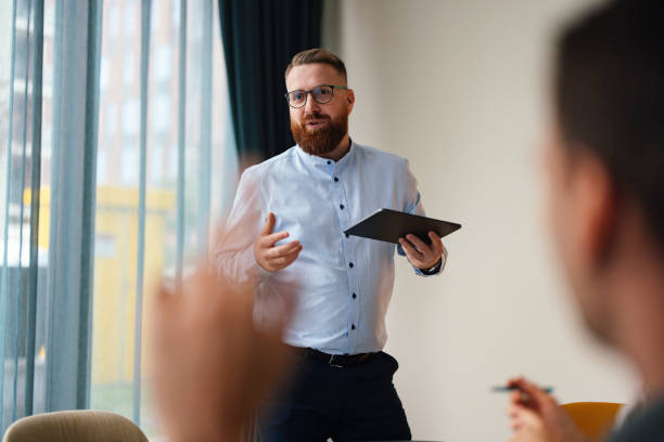 Confident Businessman Presenting Ideas at Office Meeting