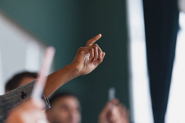 istock Raised Hand Signaling Agreement in a Group Meeting 2003613064