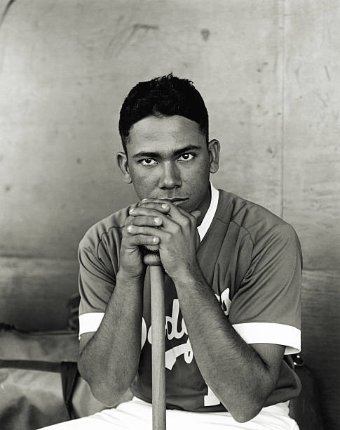 Baseball player leaning on bat, portrait (B&W)  pro baseball player stock pictures, royalty-free photos & images