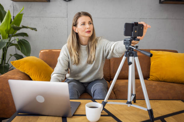istock Mature woman filming vlog at home 2003644957