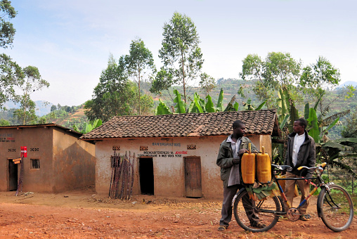 Pune, India - June 18 2023: Young Indian man on a motorcycle on a rural road at Uruli near Pune India.