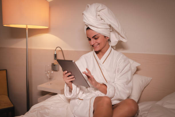 istock Young businesswoman using a tablet in a hotel room 2003800887