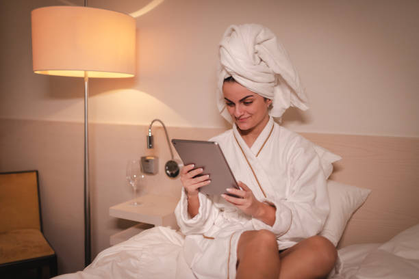 istock Young businesswoman using a tablet in a hotel room 2003800893