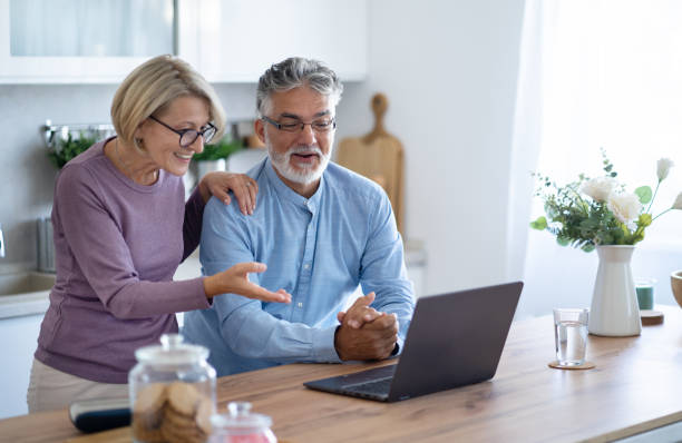 istock Happy senior couple using laptop together 2003812457