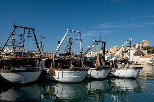 Sciacca, Sicily, Italy Jan 18, 2024 Fishing boats in the old harbor and skyline of the city.
