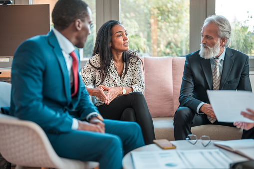 In a cozy meeting room, a diverse group of professionals collaborates during a productive business meeting.