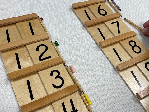 Various Montessori math materials used to instruct children in addition, subtraction, multiplication, and division, as well as other meaningful concepts like time, skip counting, quantity, and place value.