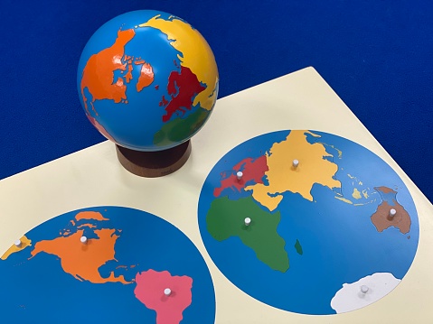 Montessori geography materials, such as the geography puzzle map and the globe.