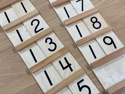 Various Montessori math materials used to instruct children in addition, subtraction, multiplication, and division, as well as other meaningful concepts like time, skip counting, quantity, and place value.