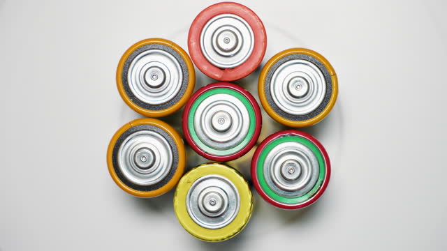 Old used batteries type D rotate in a circle