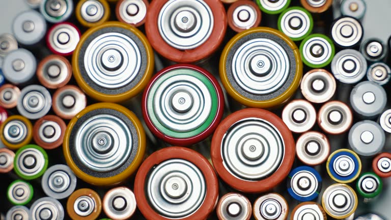 Rows of used alkaline AA, AAA, D batteries. Lithium ion battery pack close up